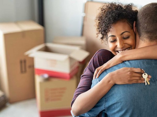 Woman hugging man and holding home keys